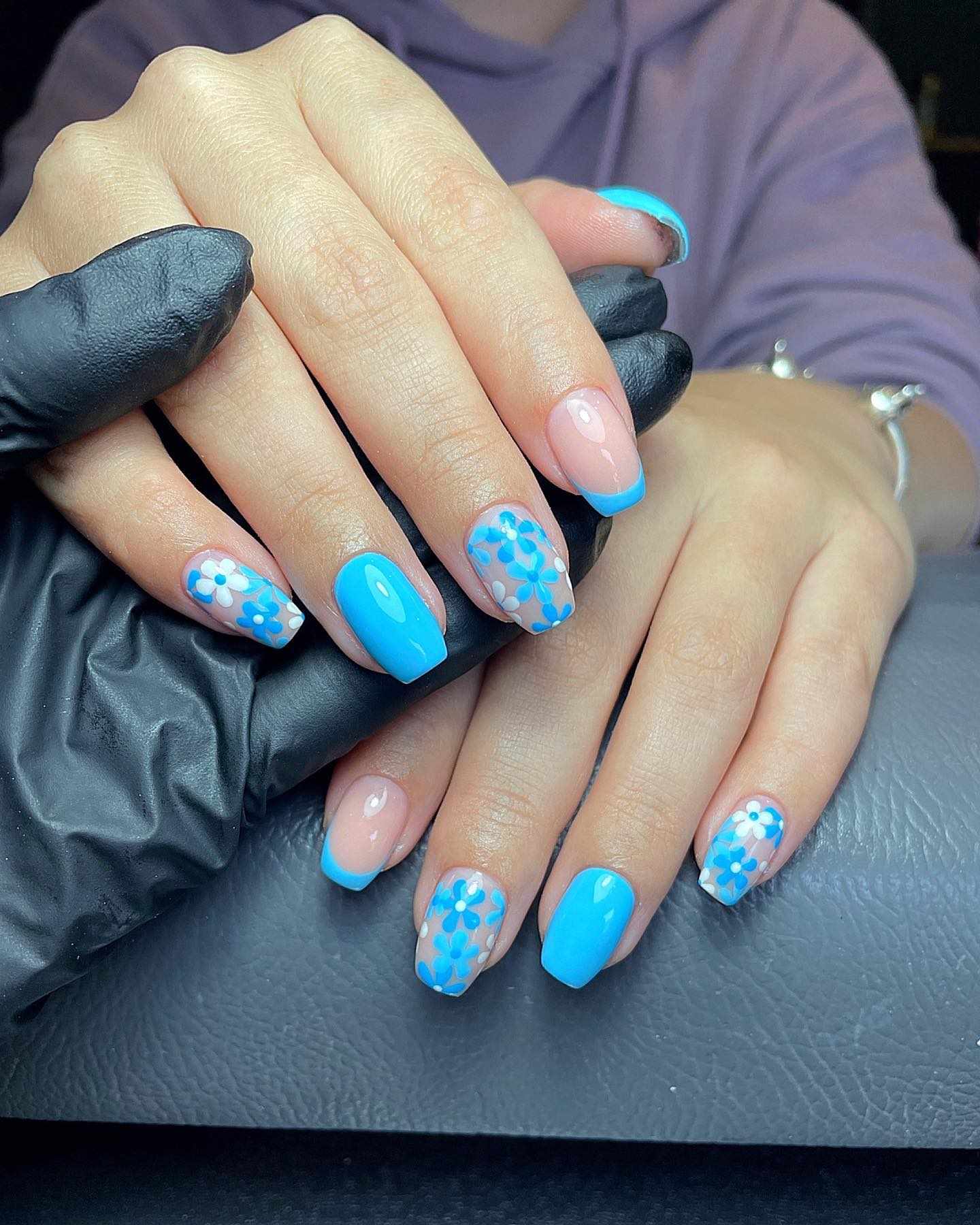 Floral nail art with blue tips