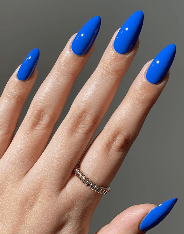Electric blue stiletto nails, bold and striking
