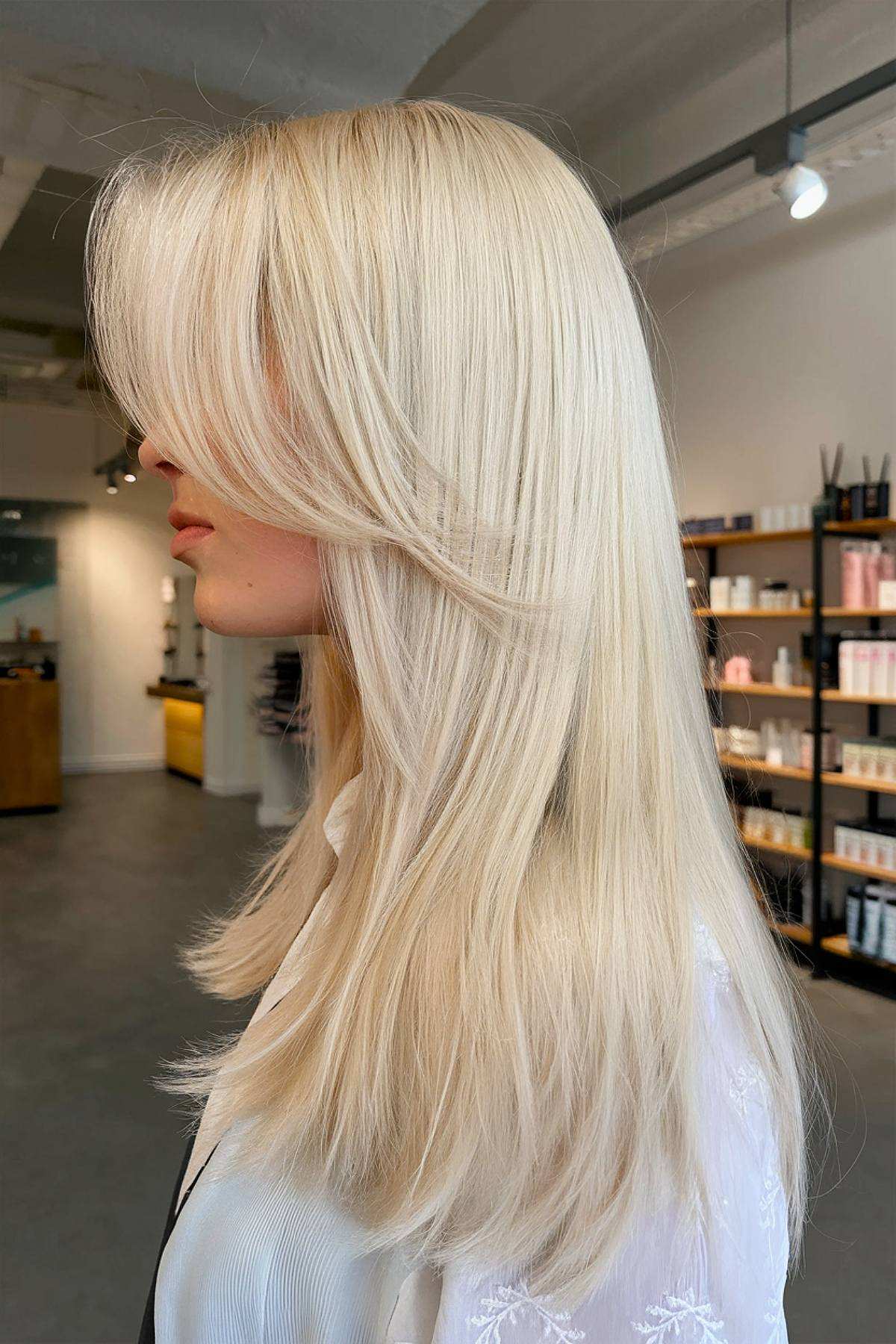 Platinum blonde layers with feathered bangs