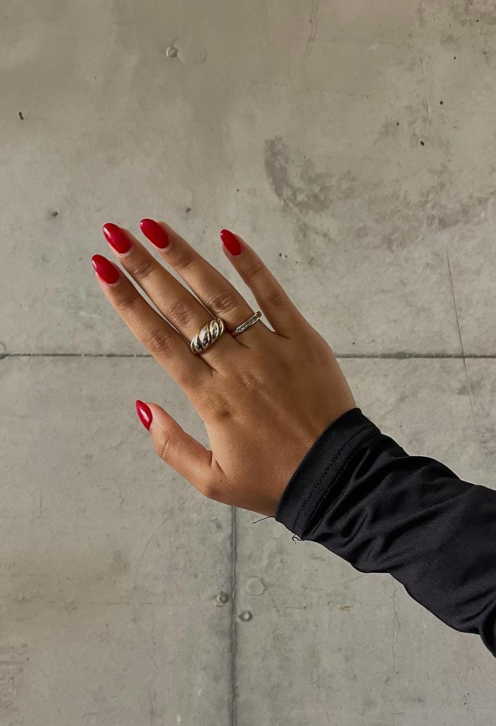 Bold red almond nails with glossy finish, statement manicure