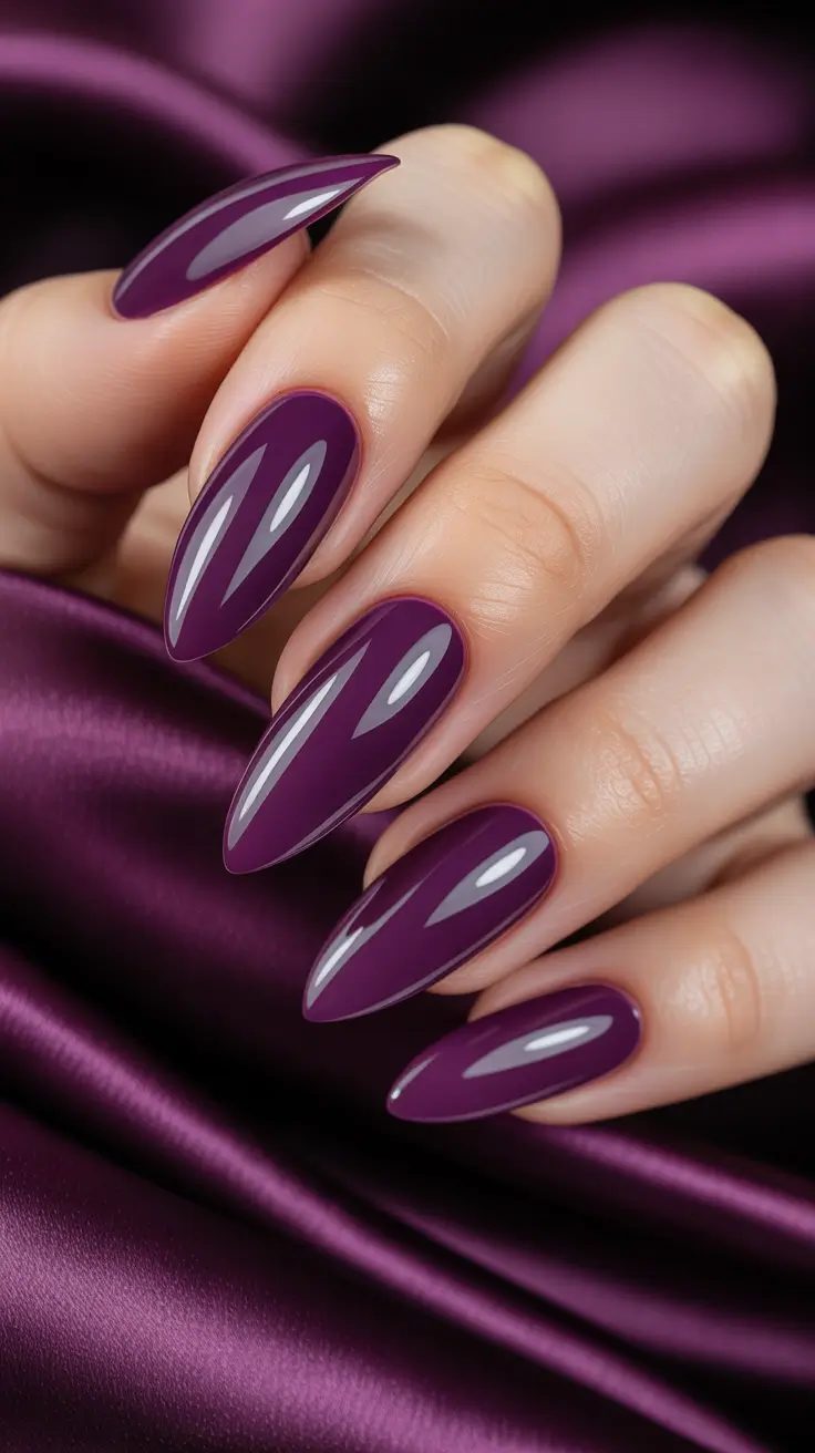 Deep plum stiletto nails, dark and luxurious manicure