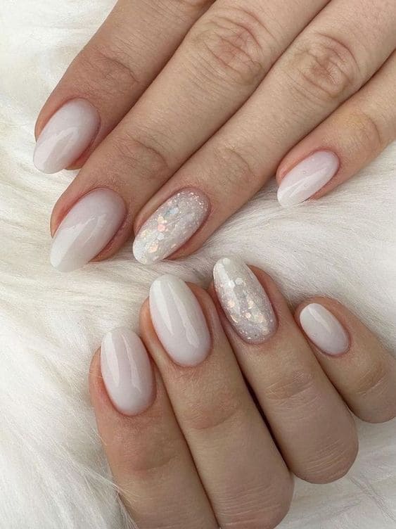Milky white nails with glitter, oval shape, elegant with sparkle