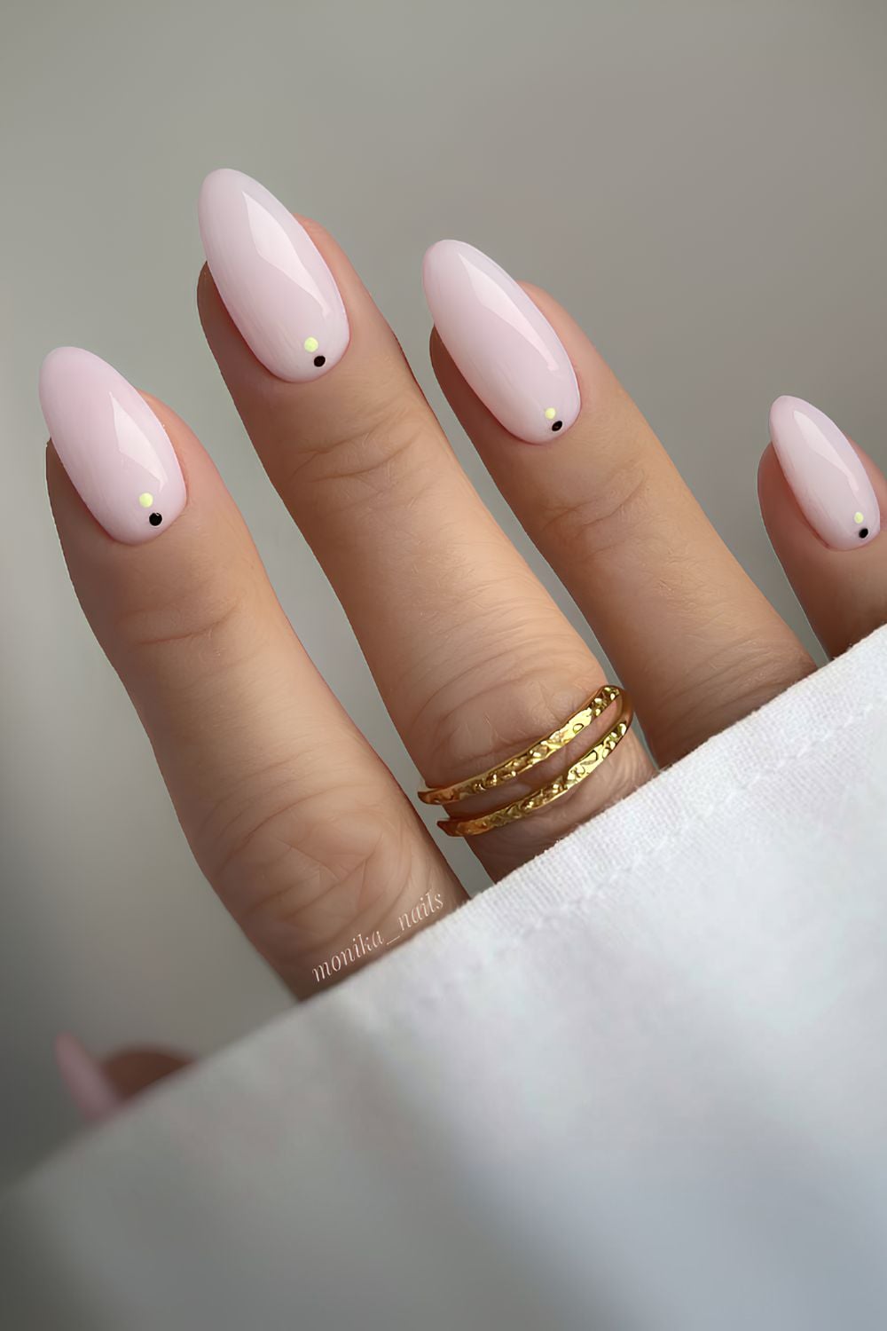 Milky pink nails with gold accents, almond shape, soft and luxurious