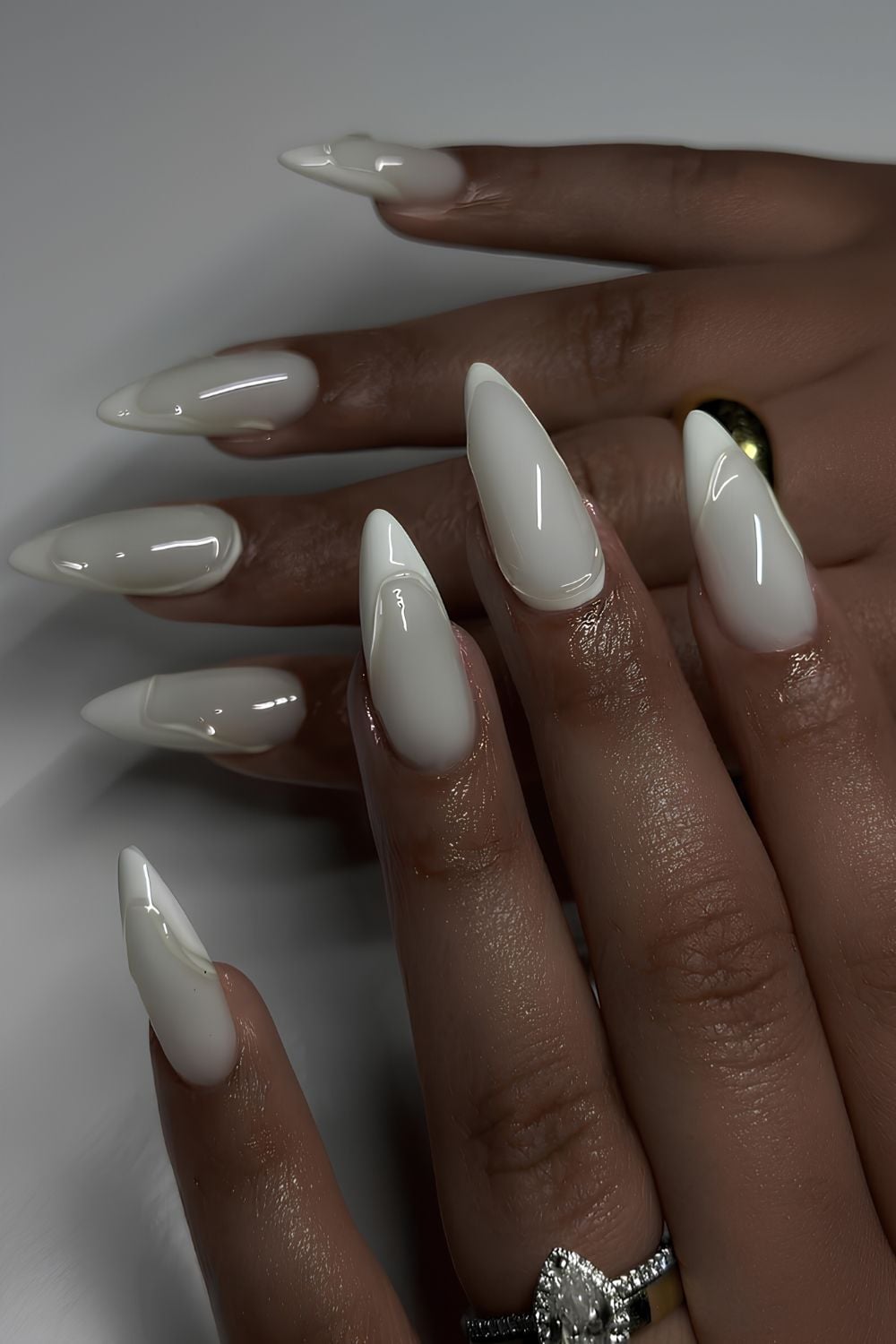 Milky stiletto nails, high-shine finish, bold and daring