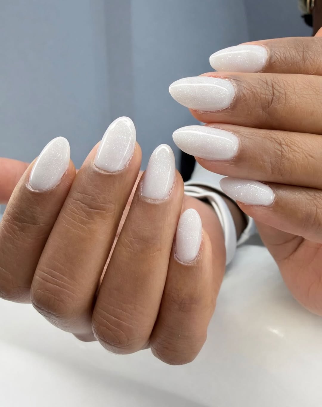Milky nails with glitter, almond shape, subtle sparkle