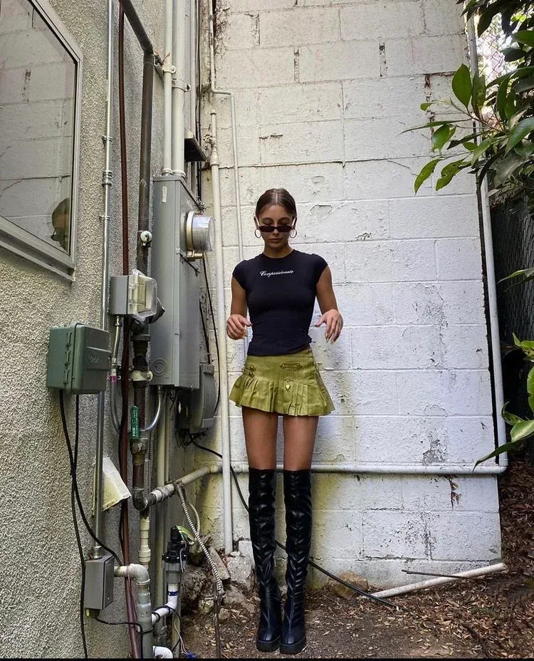 Black t-shirt and olive mini skirt with boots