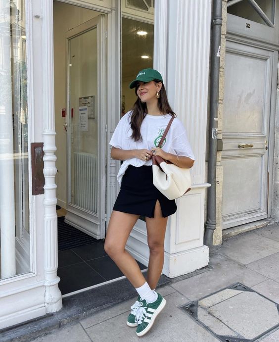 Graphic tee and black mini skirt with sneakers