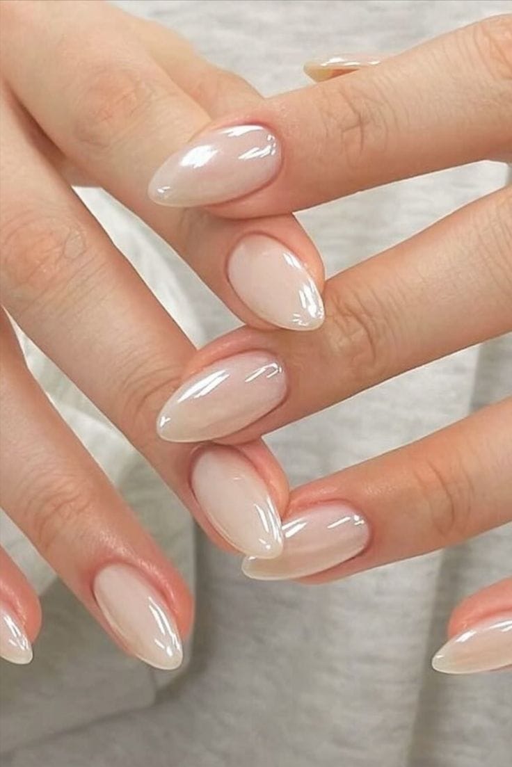 Minimalist opalescent almond nails with a glossy sheen.