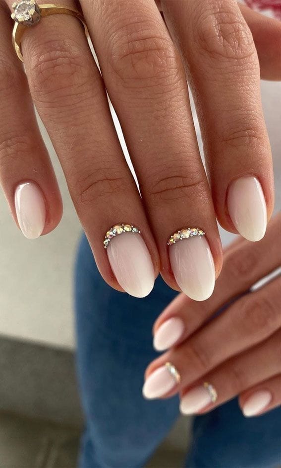 Pearl nails with crystal accents on almond shape.