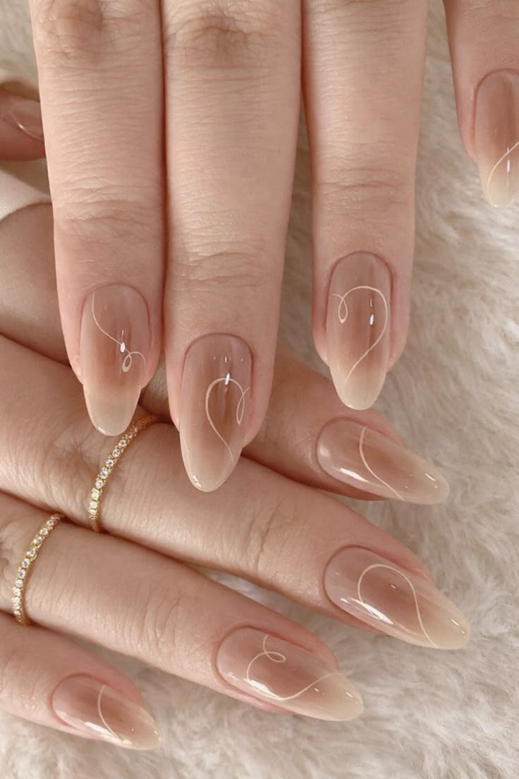 Nude almond nails with white swirl art.