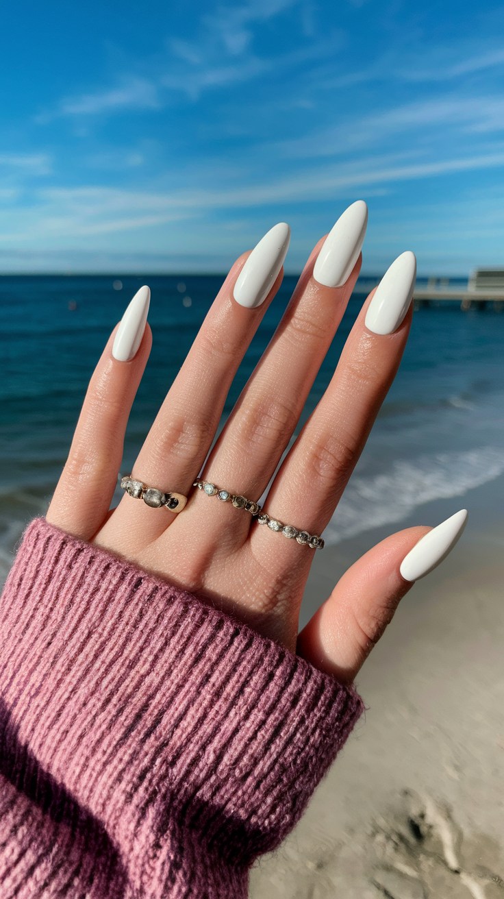 Long almond nails with bold white polish.