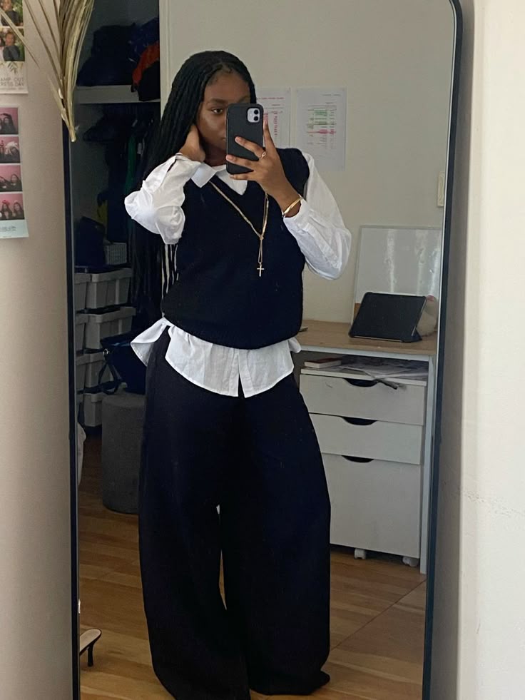Black vest over white shirt with trousers