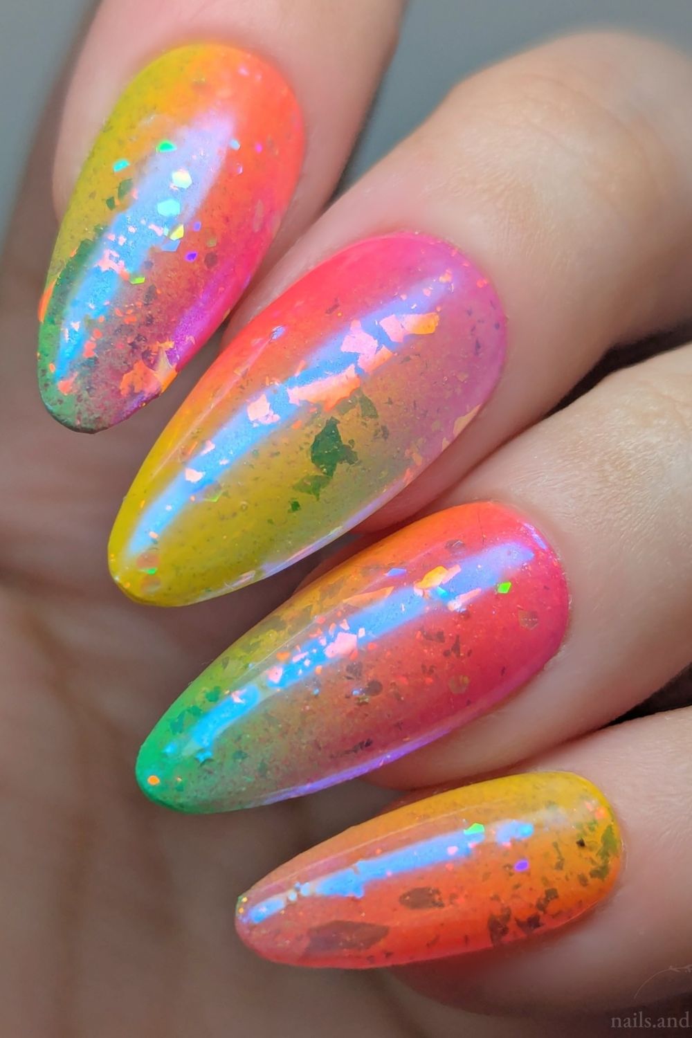 Colorful flake-filled iridescent nails with rainbow hues