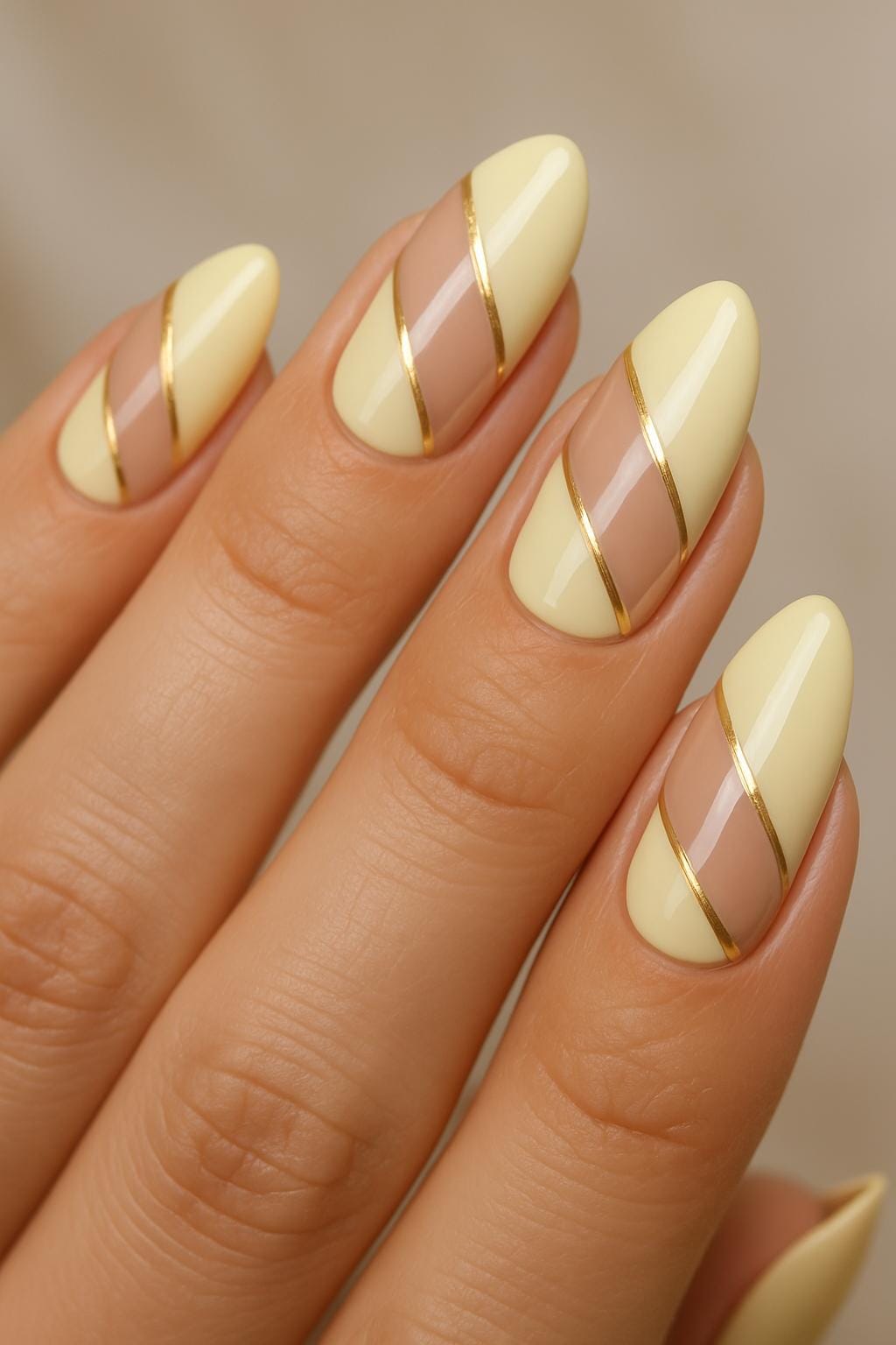 Yellow and nude geometric nails with gold accents