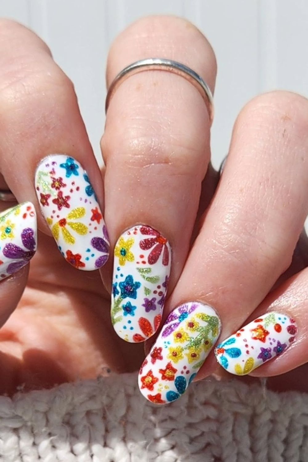 Colorful floral nail art with white base