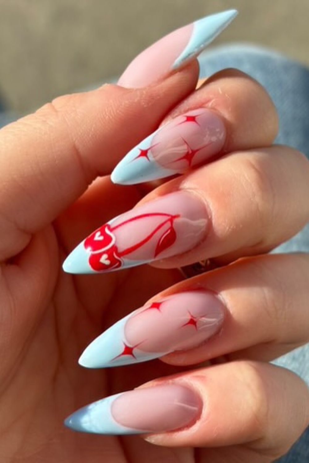 Blue stiletto nails with red floral accents