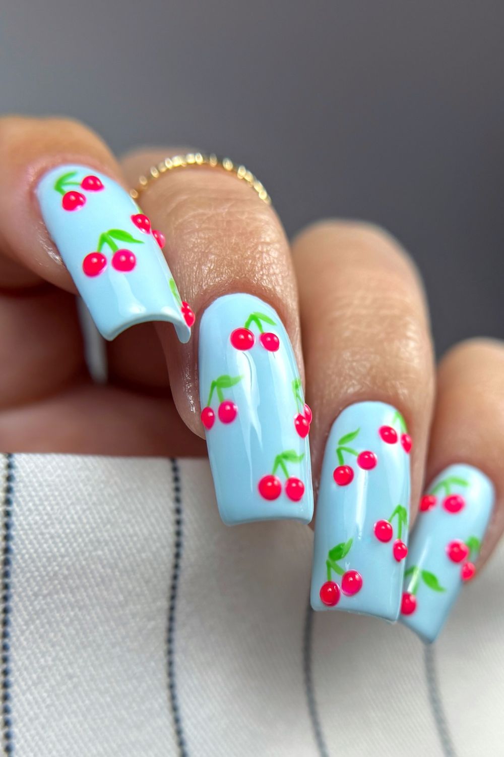 Blue nails with cherry designs