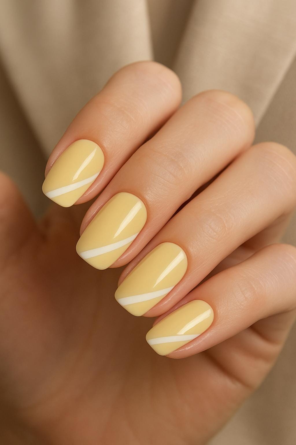 Yellow nails with diagonal white lines