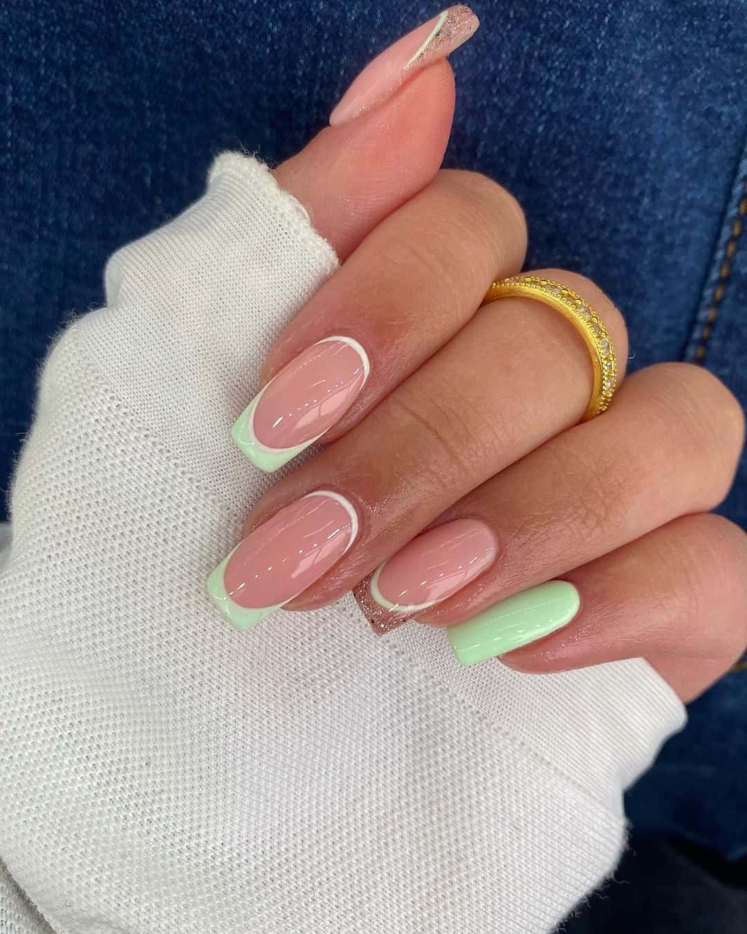 Pastel French manicure with mint and peach accents, modern twist on classic nails