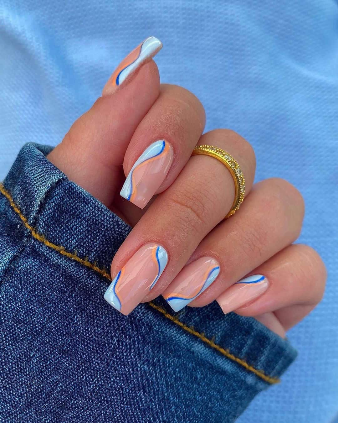 Abstract blue wave design on short square nails, modern nail art