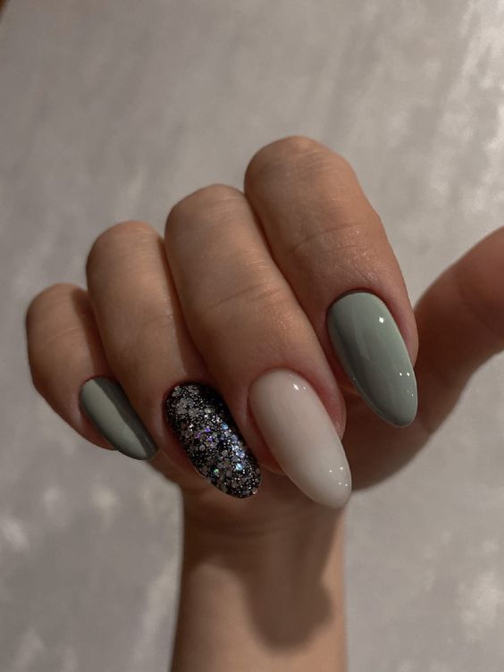 Muted green and glitter nails, almond shape