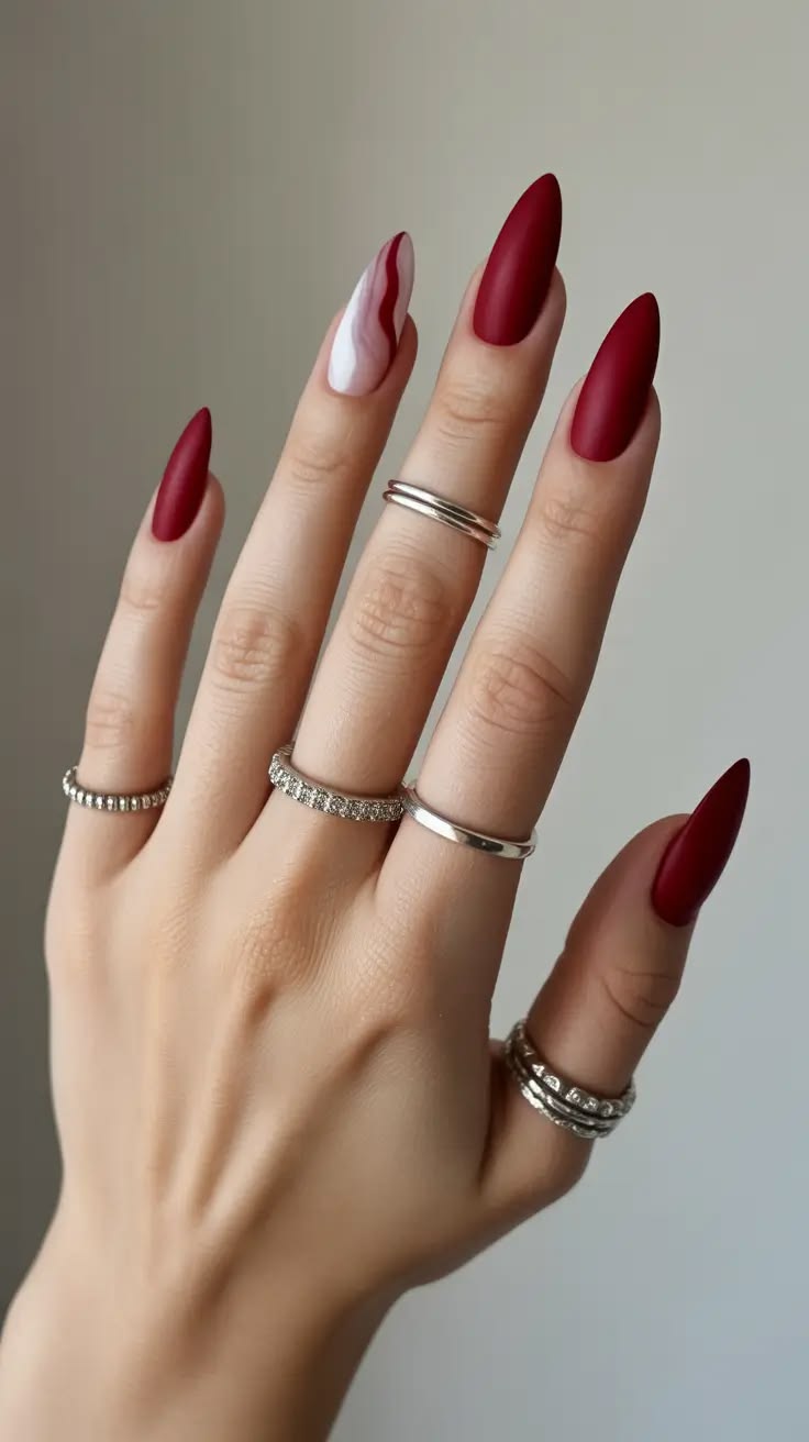 Matte red stiletto nails with abstract accent