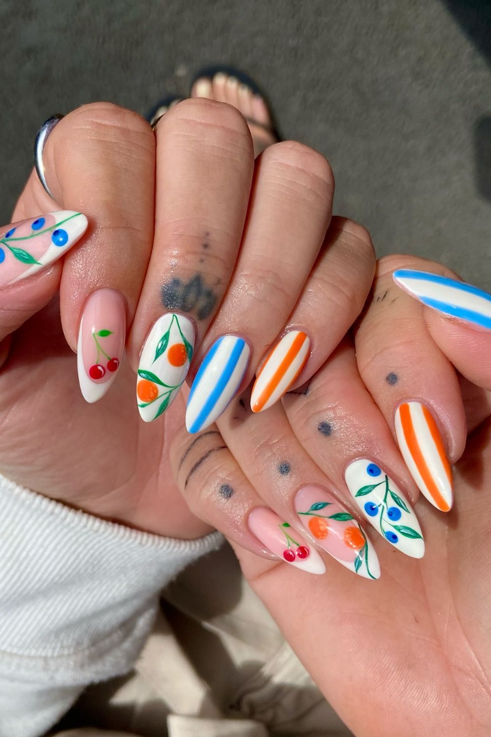 Fruity almond nails with colorful stripes