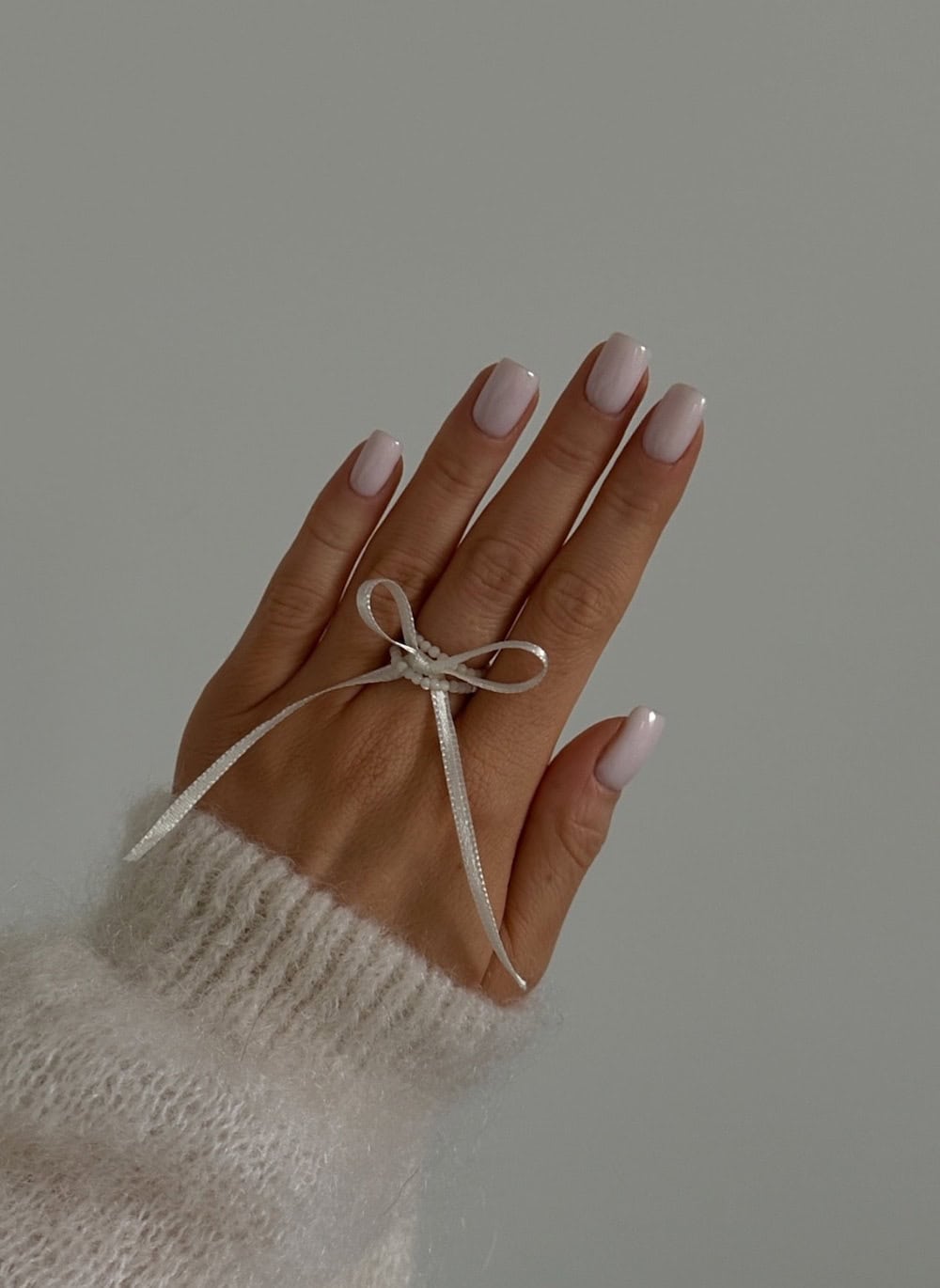 Soft pink nails, short squoval, classic elegance.