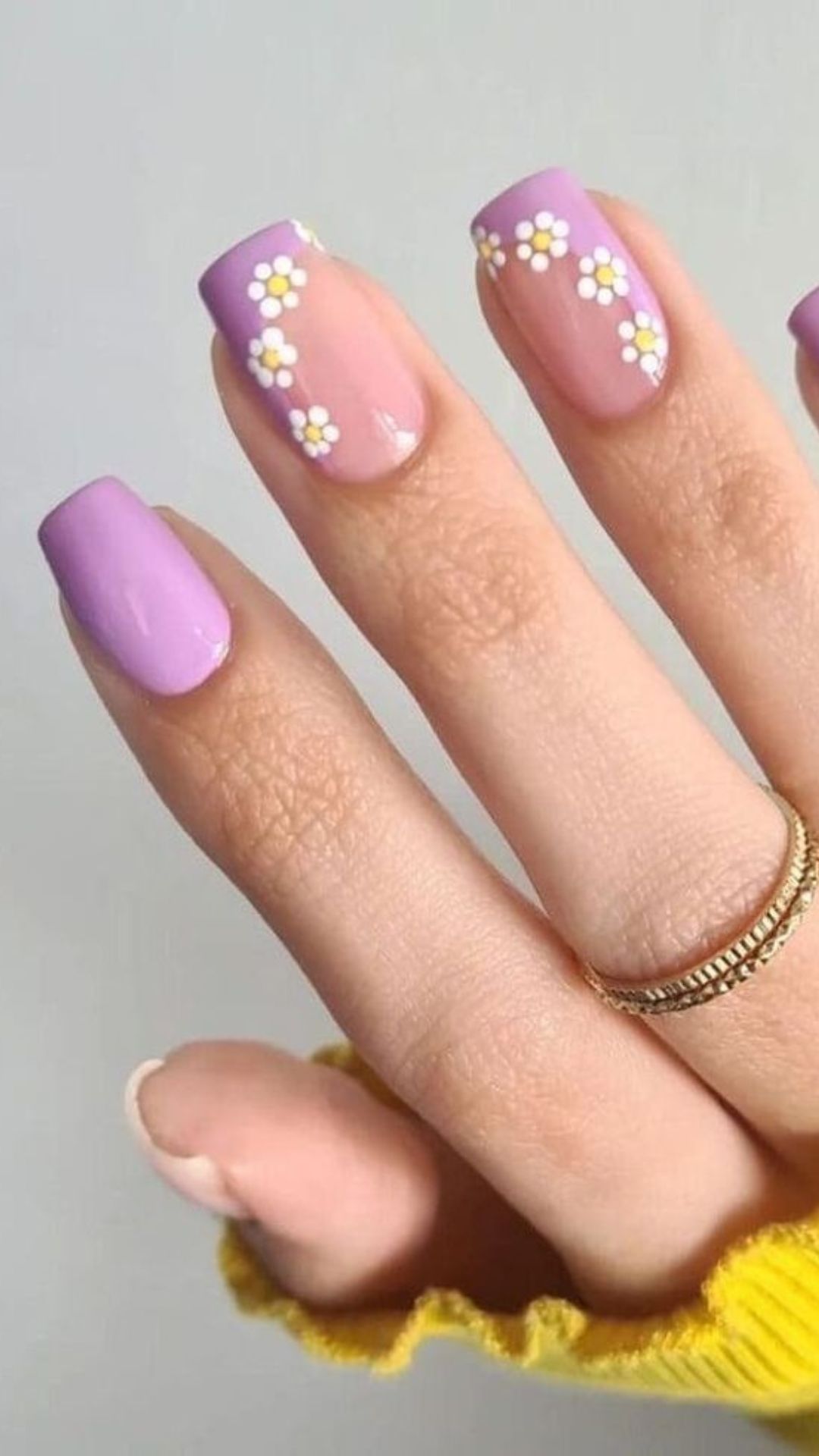 Purple nails with daisy accents, playful and feminine.