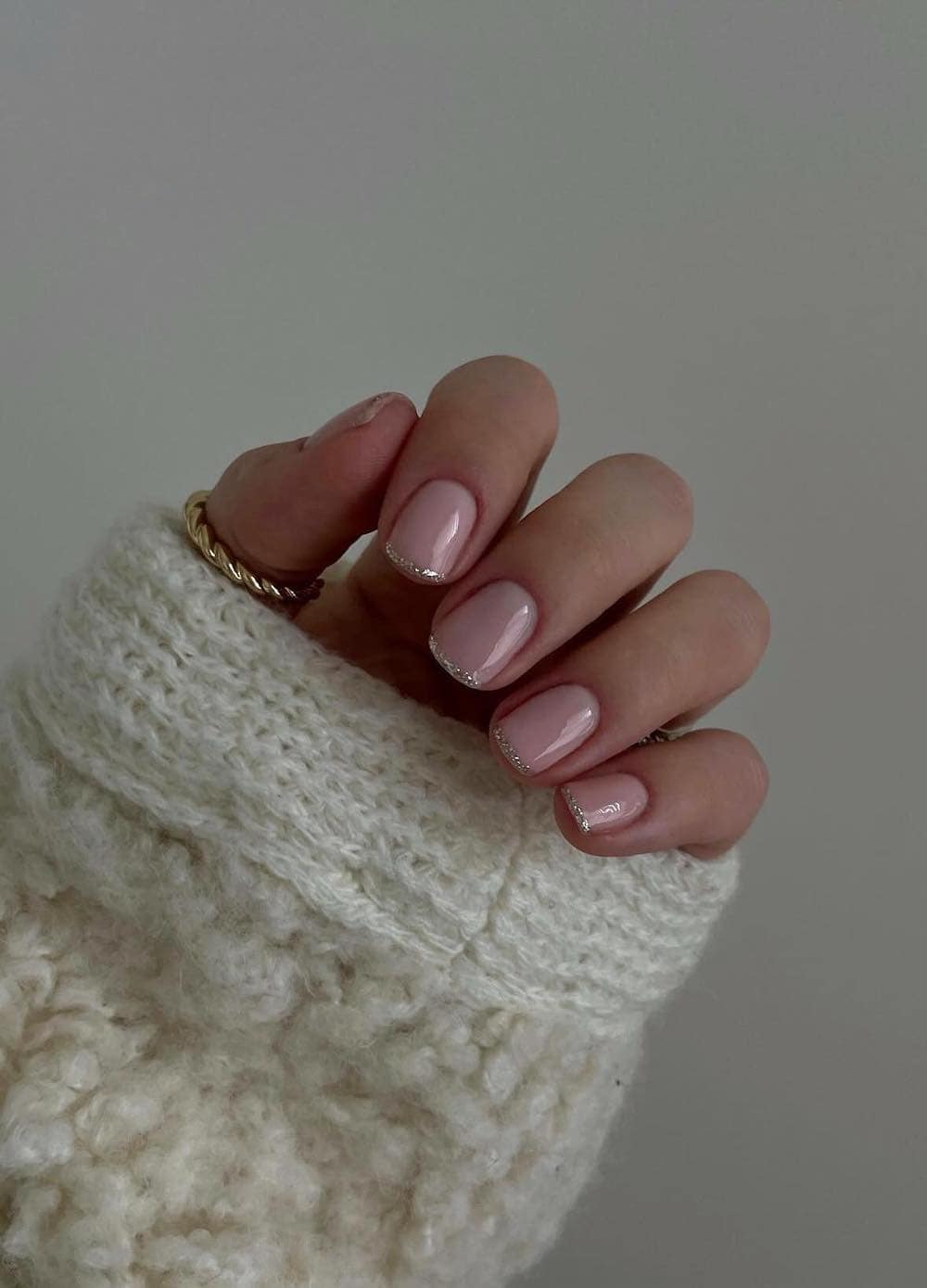 Minimalist glitter French manicure on short nails, combining subtlety with sparkle.