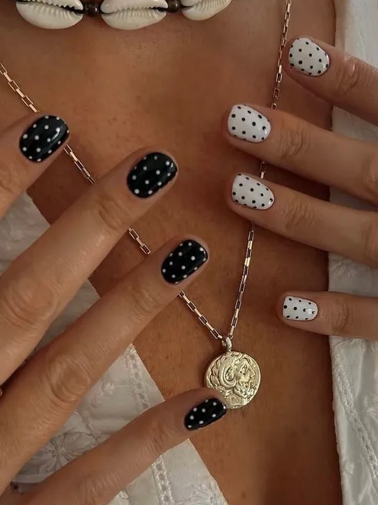 Chic polka dot nails in black and white for classic Pinterest style.