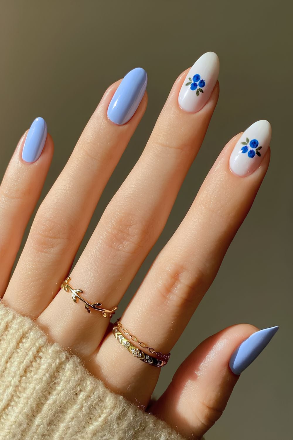 Blue floral nail art with white accents, perfect for Pinterest elegance.