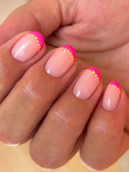 Neon pink French tips with dots.
