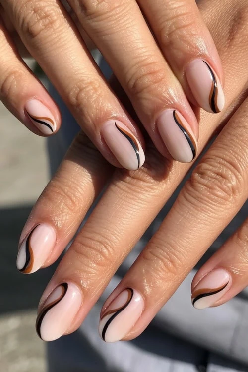 Muted nude nails with elegant swirls.