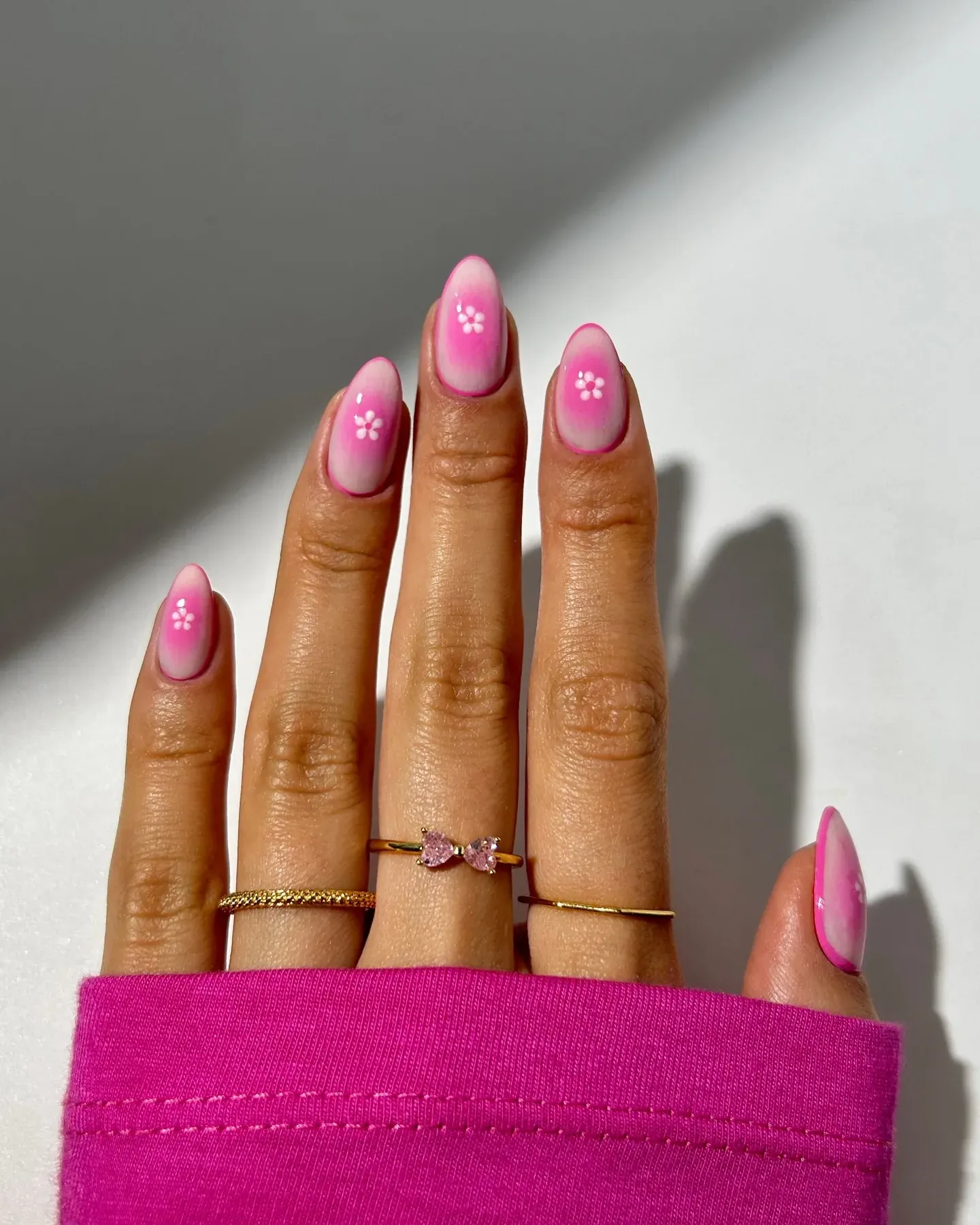 Pink nails with delicate floral accents.