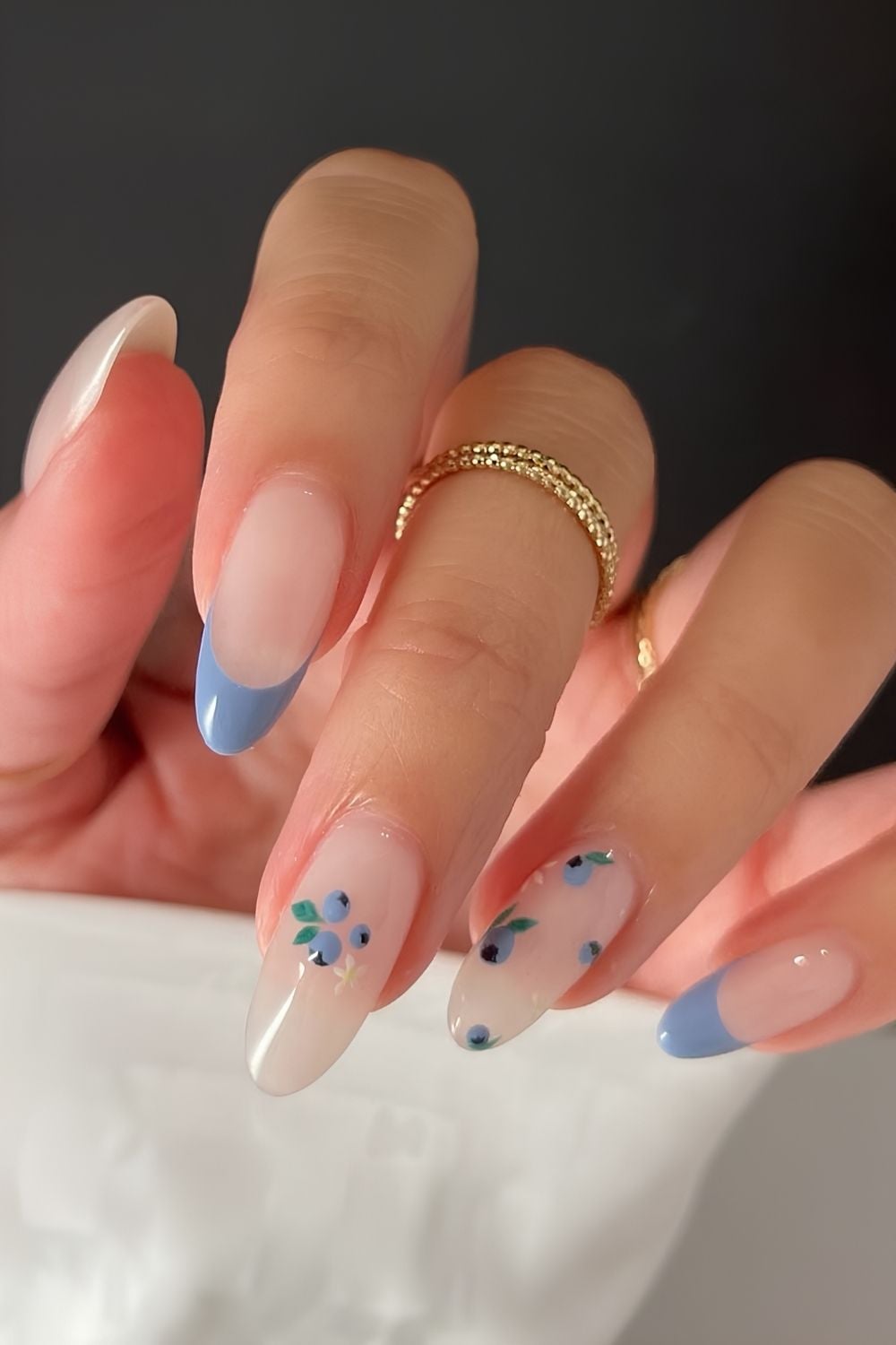 French tips with blue accents and floral details.