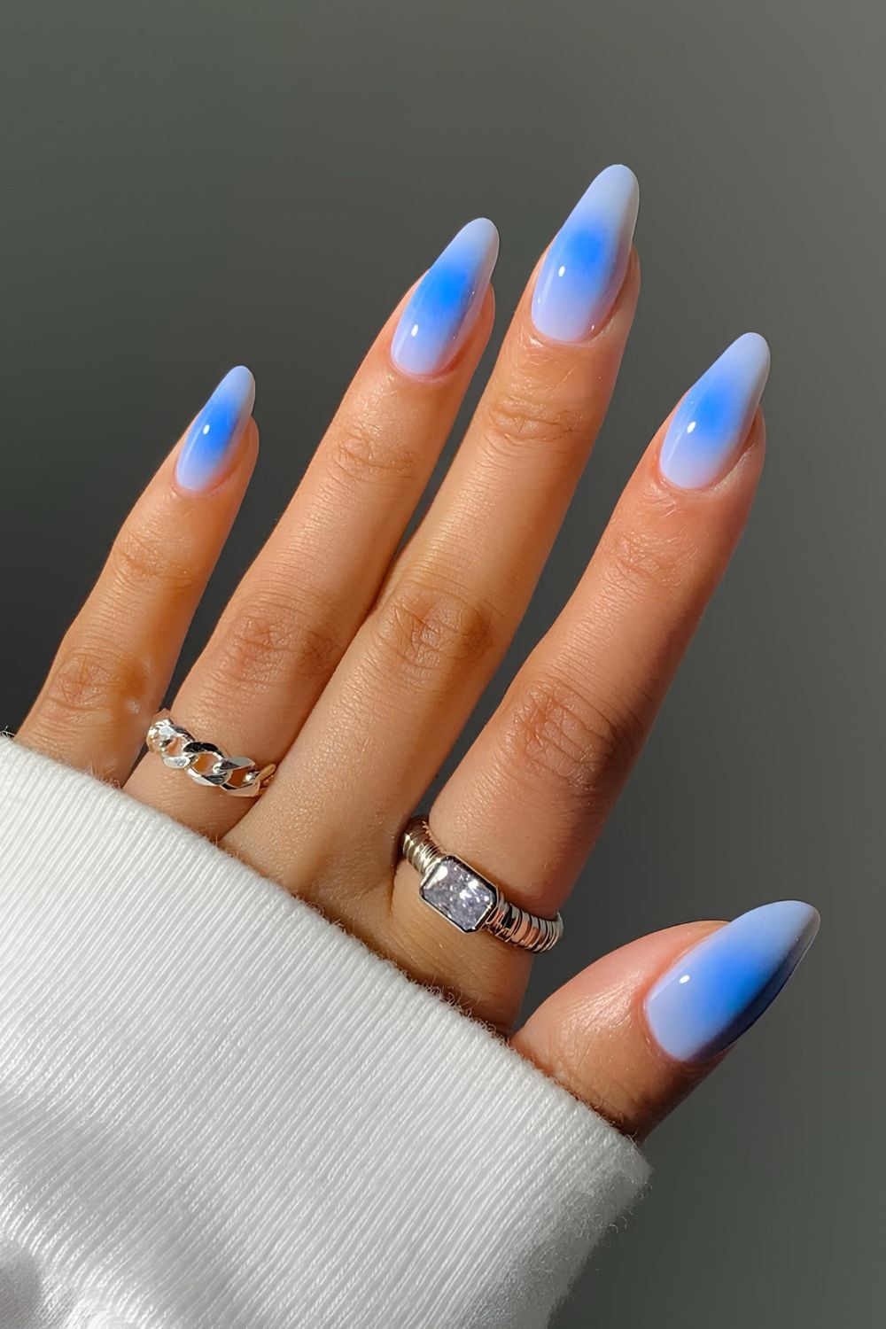 Sky-blue ombre nails with a dreamy effect.