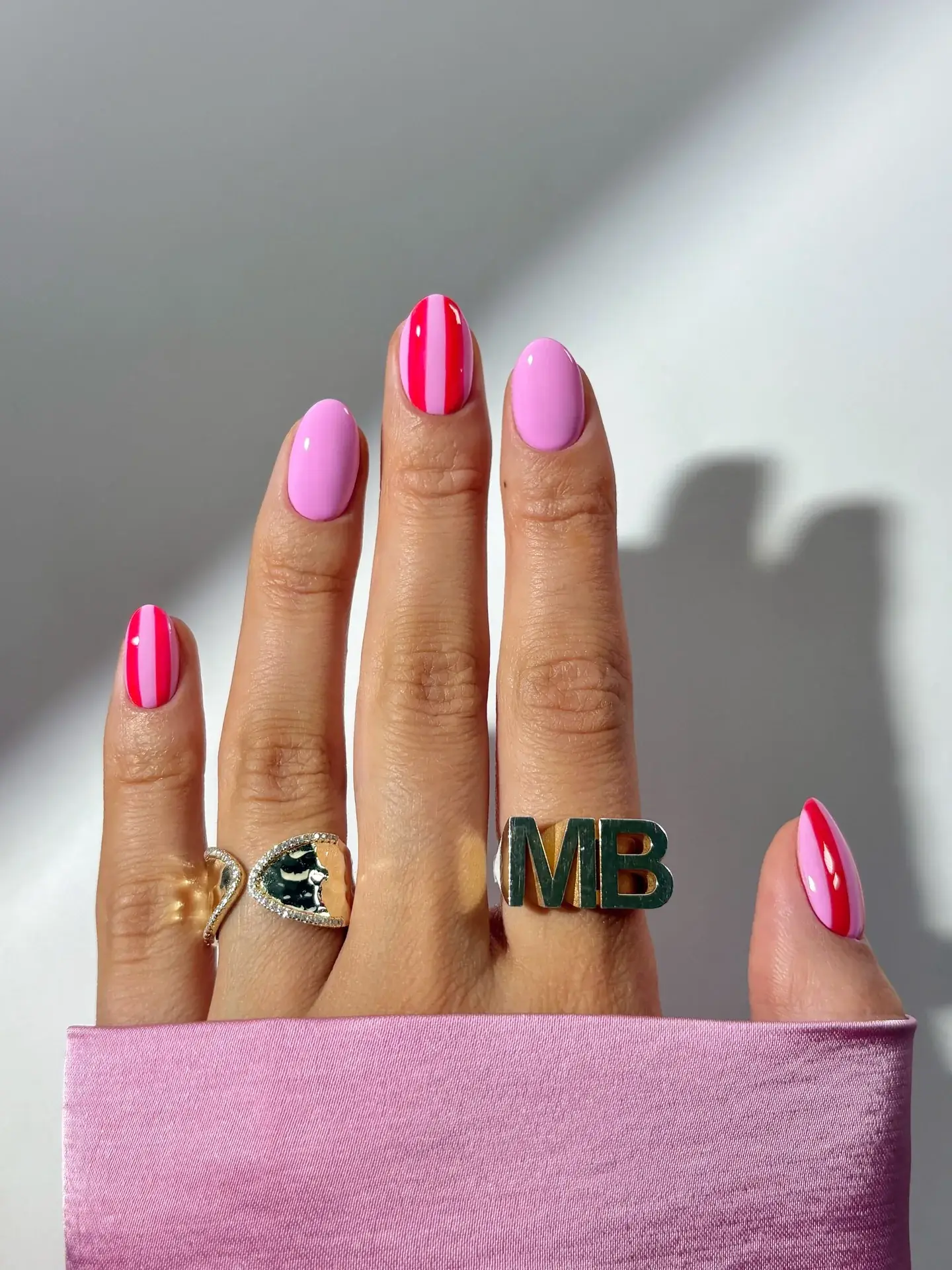 Vivid pink nails with bold stripes.