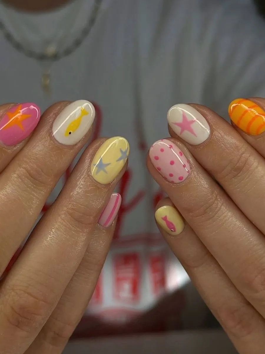 Playful pastel nails with various designs.