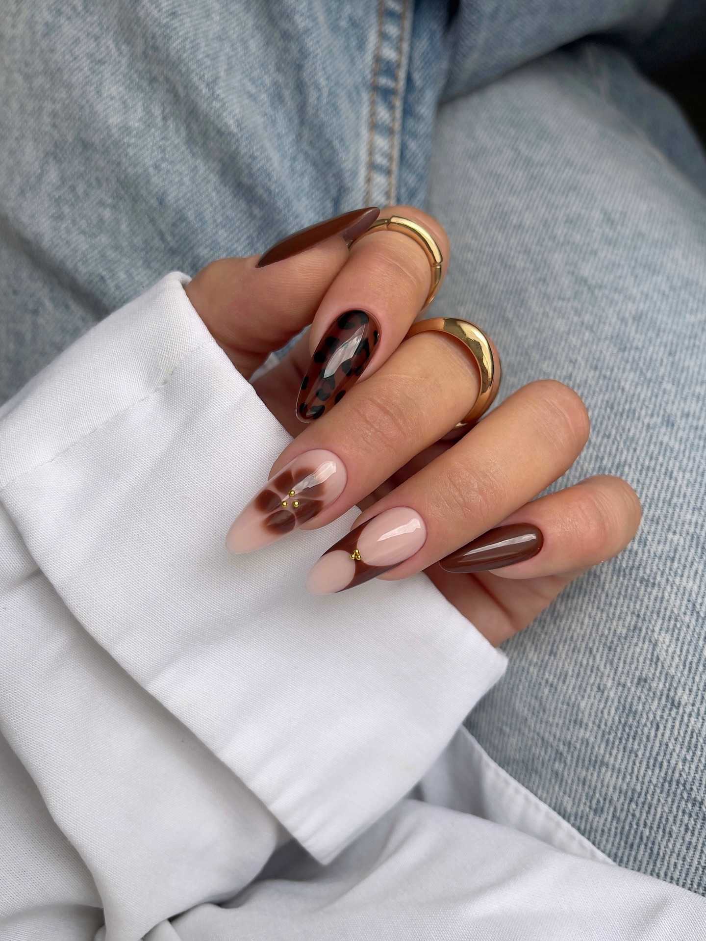 Almond nails with mocha art, chic and modern.