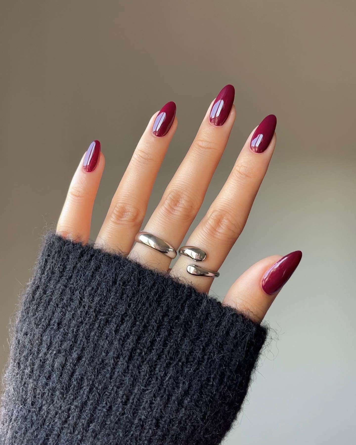 Plum almond nails, glossy and sophisticated.