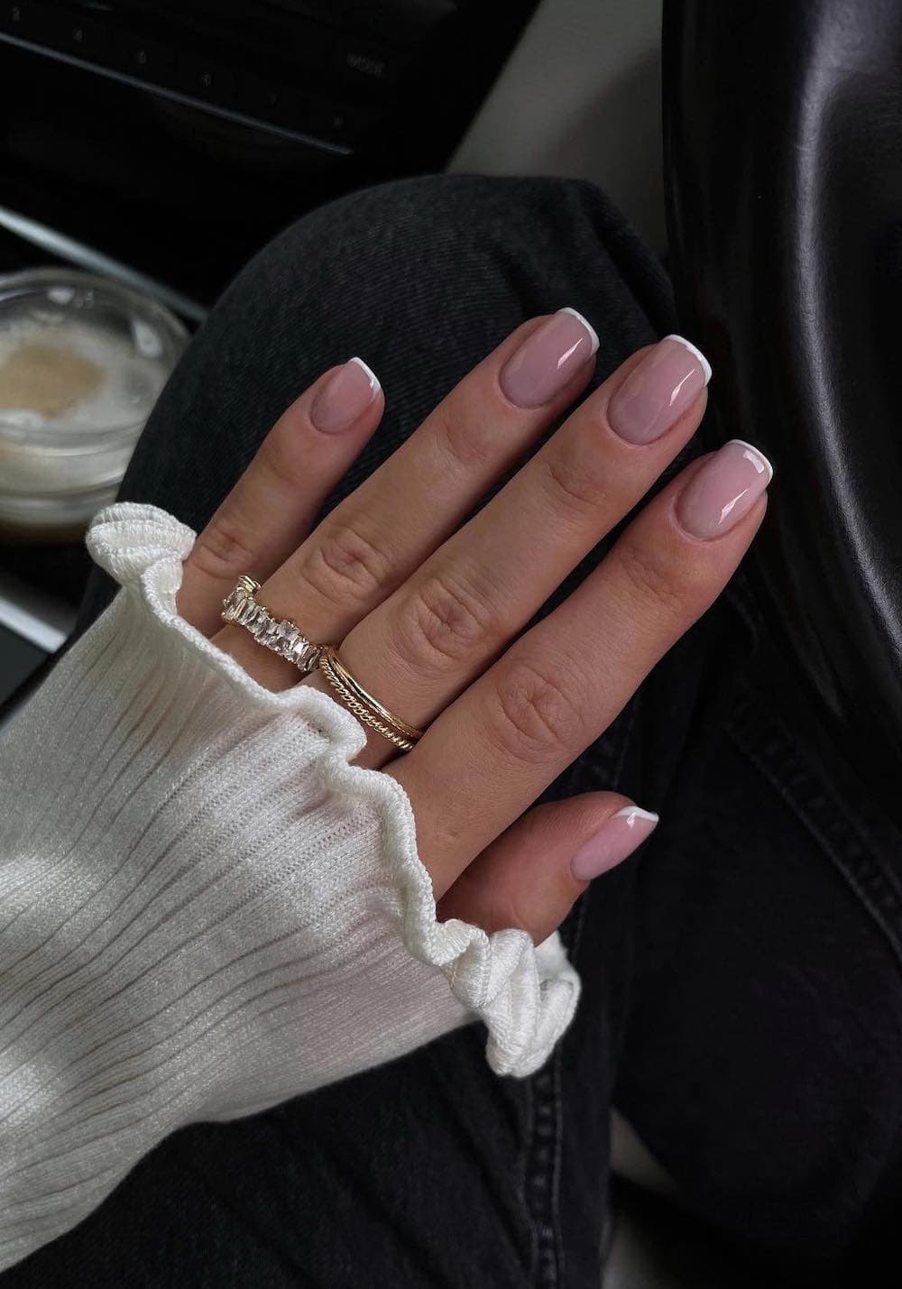 Nude micro-French almond nails, timeless elegance.