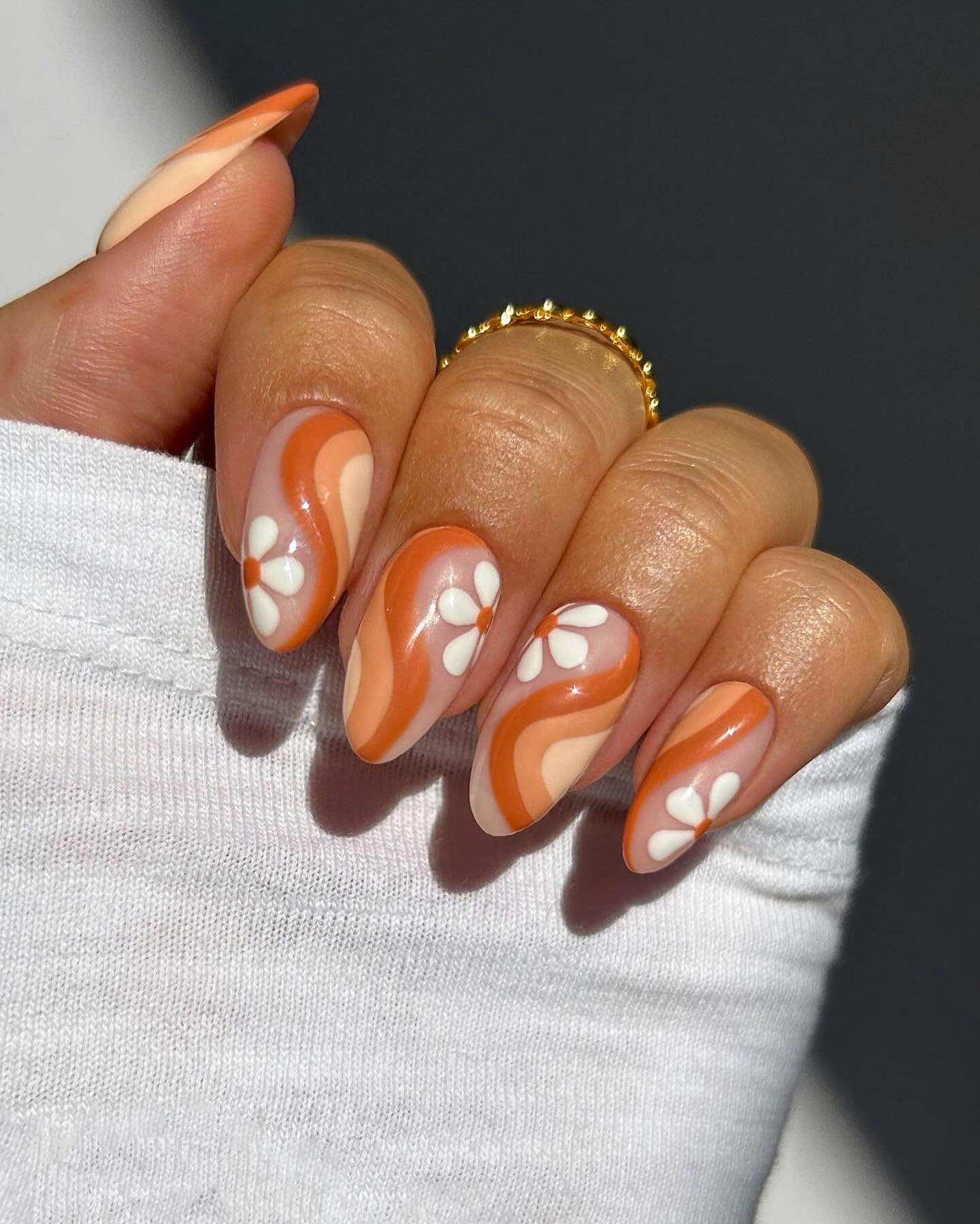 Retro floral almond nails, orange and cream.