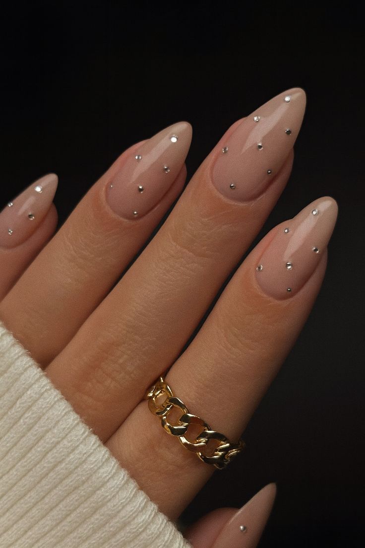 Nude almond nails with minimalist sparkle.