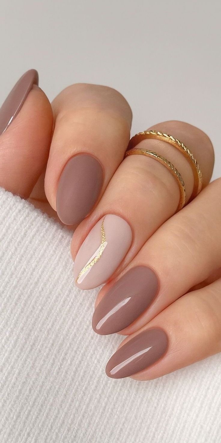Mocha almond nails with gold accent.