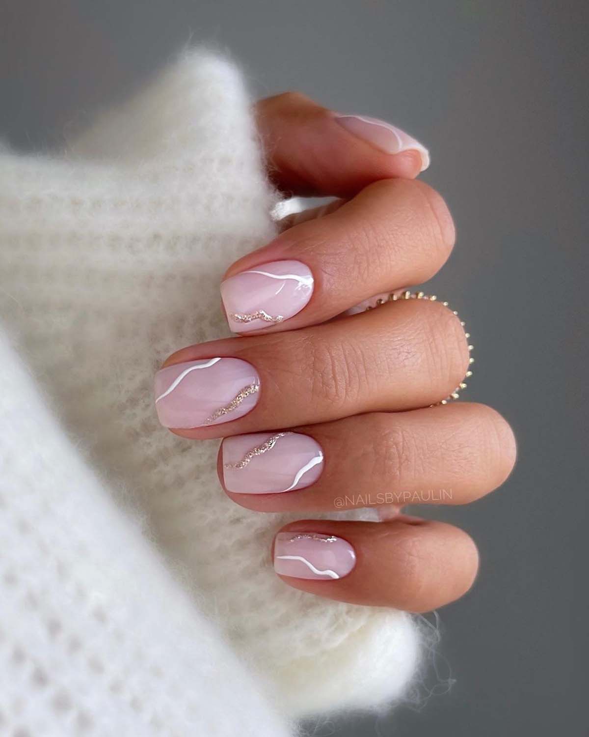 Marble nail art with soft pink and white swirls