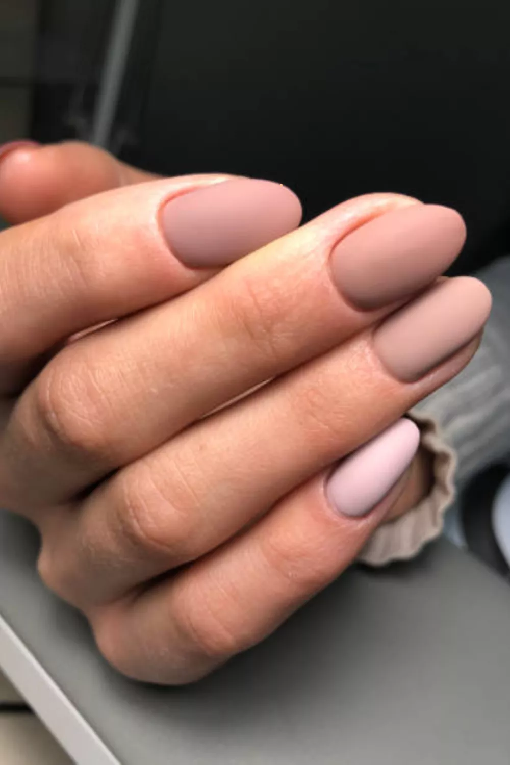 Matte nude nails with a soft almond shape