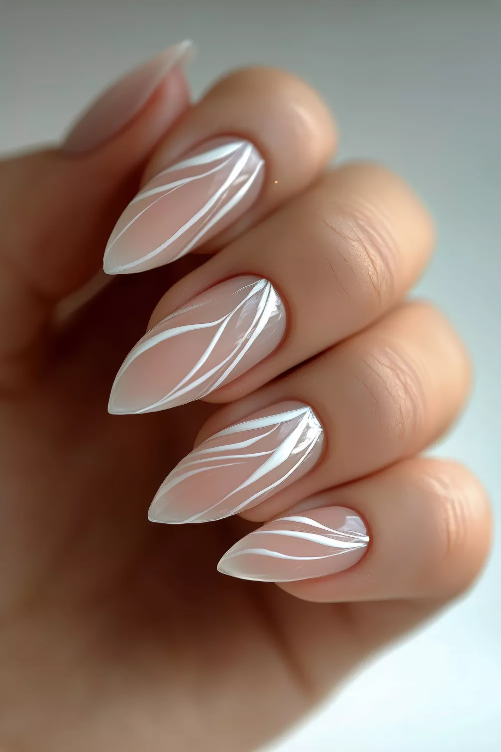 Leaf pattern nail art on pointed almond nails
