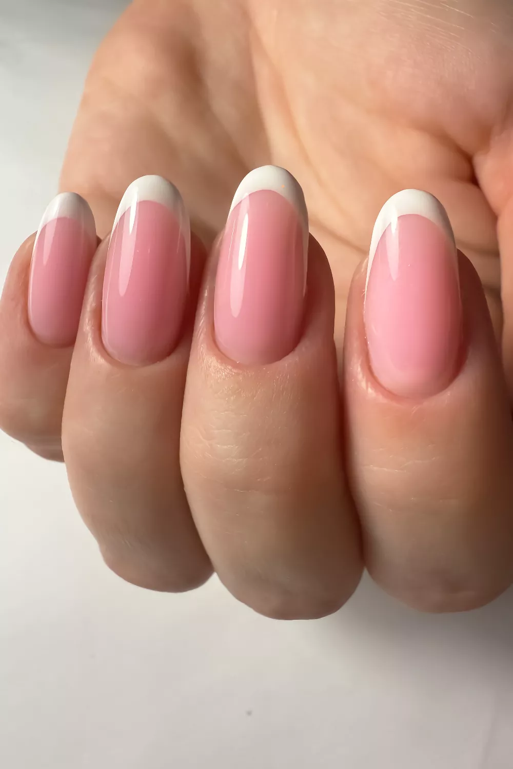 Classic French manicure with a modern pink base