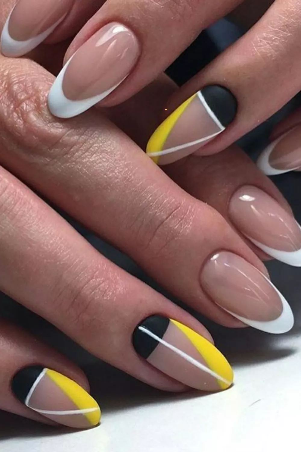 Geometric nail art with yellow and black